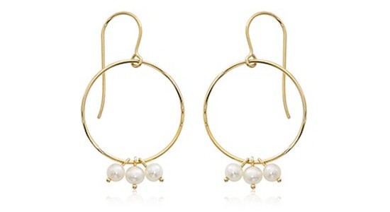 a pair of hoop earrings featuring three pearls