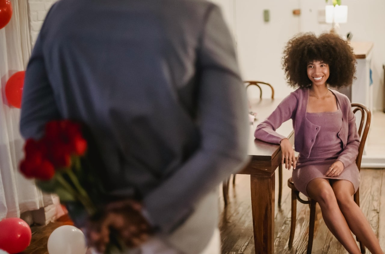 A man surprising his Valentine with flowers and a romantic date