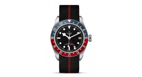 A stainless steel TUDOR watch with a blue and red bezel and a sporty strap, available at Exclusively Diamonds.