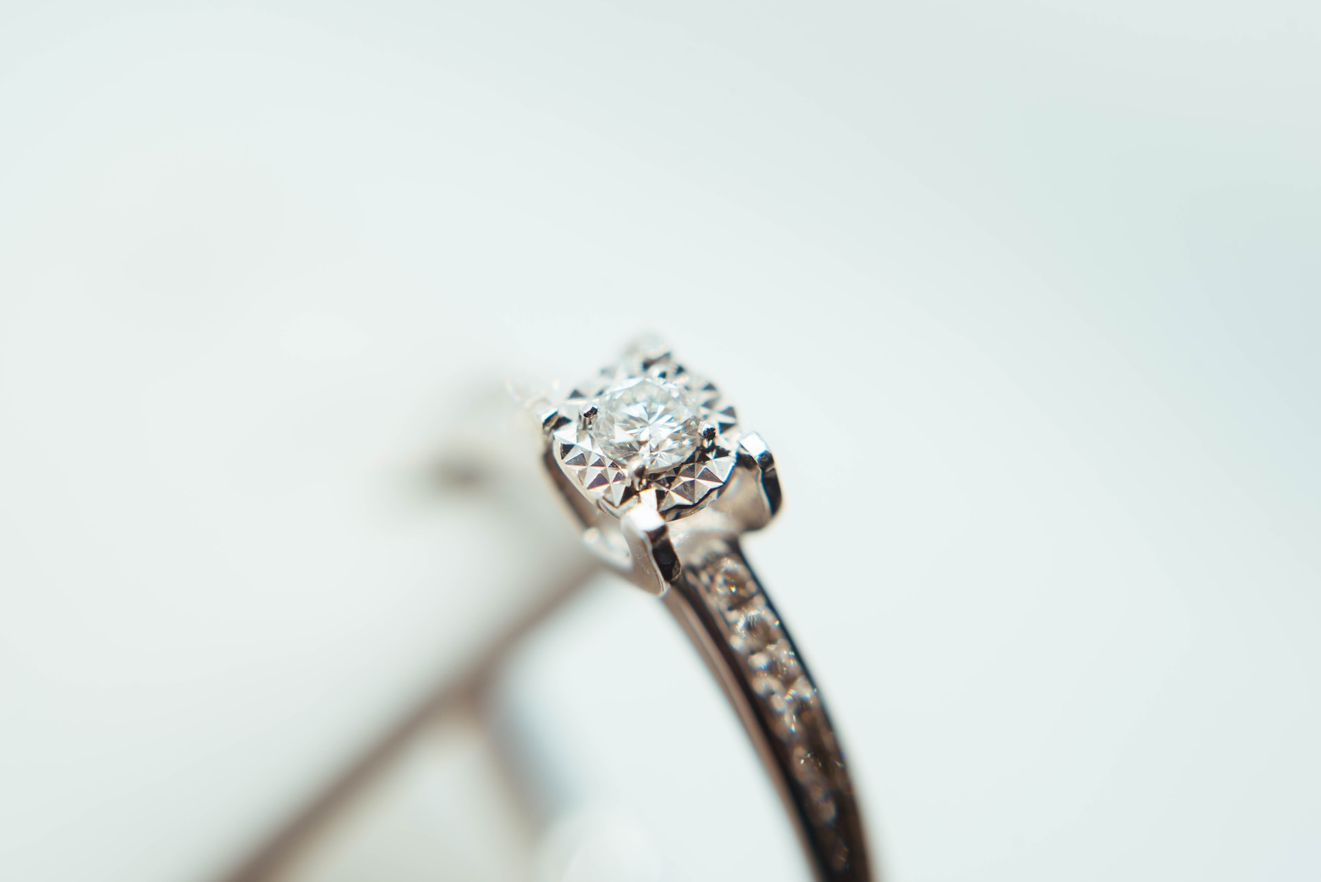 a round cut engagement ring featuring channel set side stones