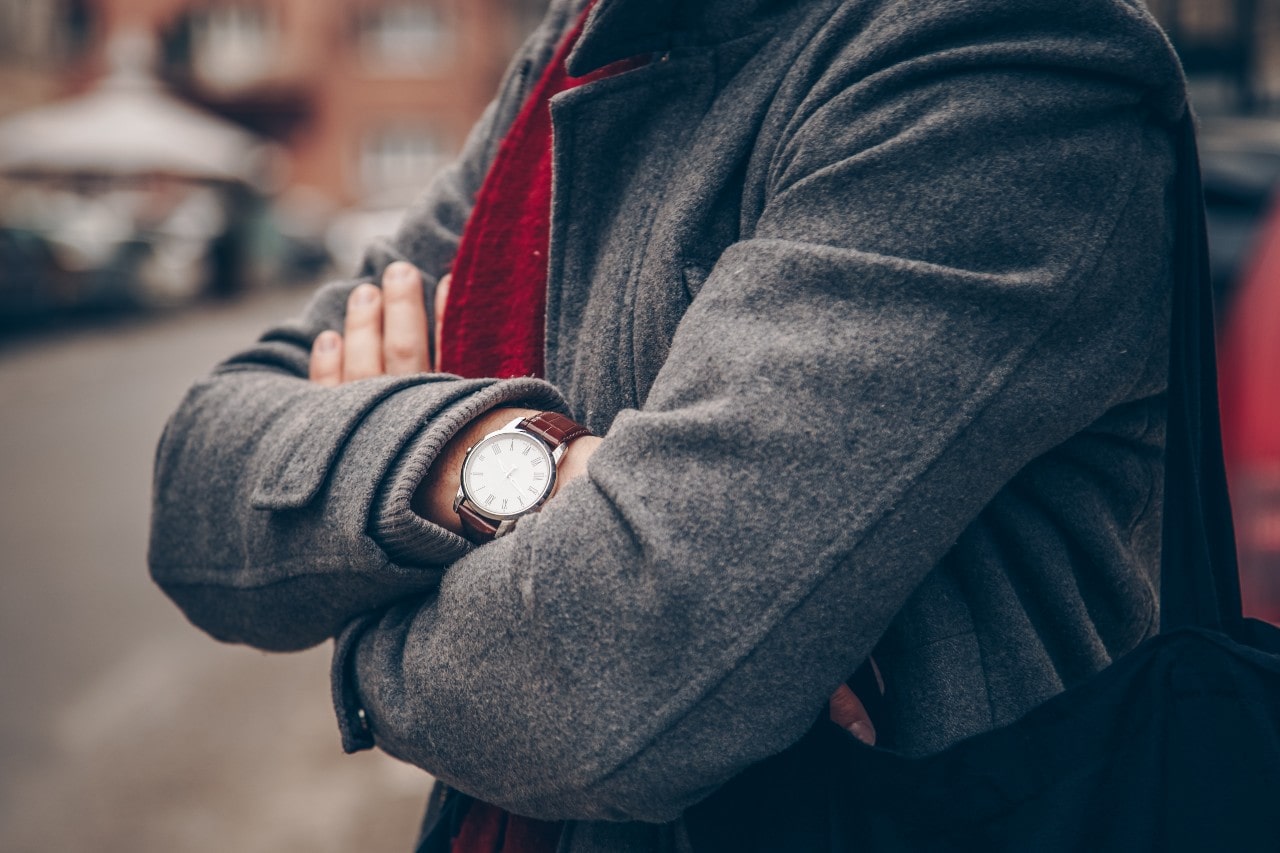 A man wearing an automatic watch with a self-winding mechanism.